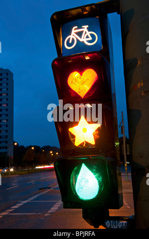 Detail of cyclist traffic lights with lamps painted to show heart, star and tear in Berlin Germany Stock Photo
