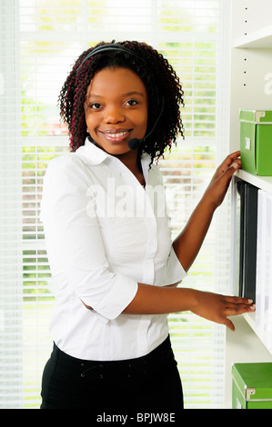 African American Businesswoman Wearing A Telephone Headset In An Office Stock Photo