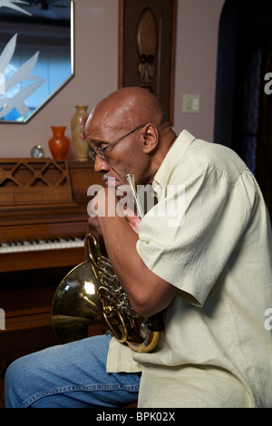 African-American man with French horn. Stock Photo