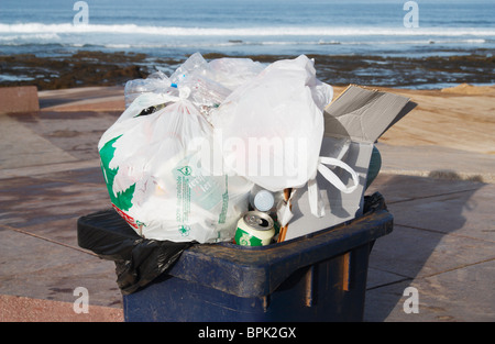 Overflowing wheelie bin on beach in Spain Stock Photo