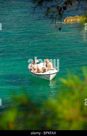 ZATON VELIKI, near DUBROVNIK, CROATIA. Three young people on a small boat in Zaton Bay. Stock Photo