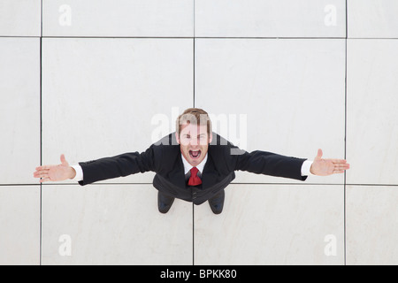 Looking down on a businessman with arms spread open Stock Photo