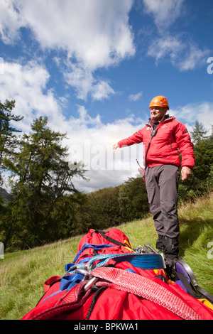 A member of Langdale/Ambleside Mountain Rescue Team uses a flare to attract an incoming Sea King helicopter Stock Photo