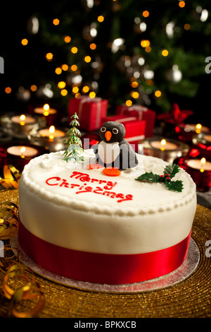 Traditional Christmas cake decorated with penguin Stock Photo