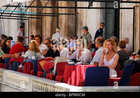 DUBROVNIK, CROATIA. Customers drinking on the outdoor terrace of Gradskavana cafe on Luza Square in Dubrovnik old town. Stock Photo