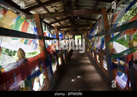 The trail to Cheri Goemba starts by crossing a prayer flag covered bridge Wang Chhu River Thimphu Valley Bhutan Asia Stock Photo