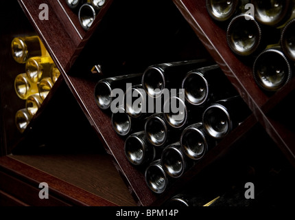 Snapshot of the wine cellar. The bottles on wooden shelves. Stock Photo