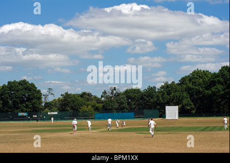 A cricket match at Busbridge Recreation Ground in Godalming in Surrey Stock Photo