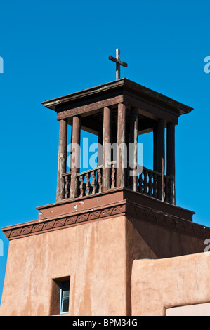 Wooden Tower on Adobe building with cross Stock Photo