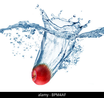 Apple falls deeply under water with a big splash. Stock Photo
