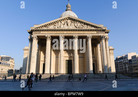 PARIS, France - Front of the Pantheon in Paris. It was originally built as a church dedicated to St. Genevieve and to house the reliquary châsse containing her relics but, after many changes, now functions as a secular mausoleum containing the remains of distinguished French citizens. It is an early example of neo-classicism, with a façade modelled on the Pantheon in Rome. Stock Photo