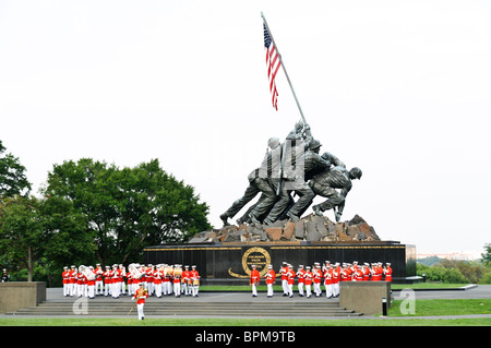 ARLINGTON, Virginia, United States — The United States Marine Drum and Bugle Corps, known as 'The Commandant's Own,' performing at the Marine Corps Sunset Parade at the Marine Corps War Memorial, also known as the Iwo Jima Memorial, near Arlington National Cemetery. This ceremonial unit is renowned for its musical precision and plays a key role in Marine Corps traditions. Stock Photo