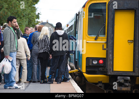 Passengers boarding train in station at Llandrindod Wells Powys Mid Wales UK Stock Photo