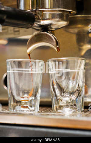 Close-up of espresso machine and shot glasses during a pour Stock Photo -  Alamy