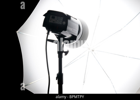 Compact studio lighting unit with white shoot-through umbrella Stock Photo