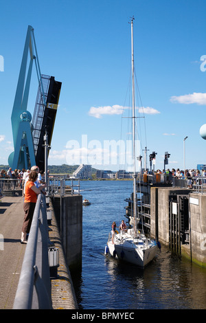 Yachts entering lock gates at Cardiff bay barrage from penarth marina en route to the Bristol channel. Stock Photo