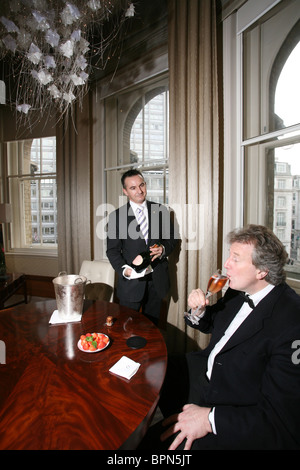 Man dressed in black tie drinking champagne served by personal butler at The Infinity Suite, Langham London .Photo:Jeff Gilbert Stock Photo