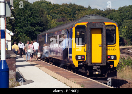 Train passengers leaving and boarding a train at Dore and Totley railway station on the Northern Line Stock Photo