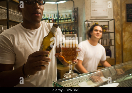 A bartender pours a glass of Birra Moretti at Eataly the Italian food and wine marketplace in New York Stock Photo