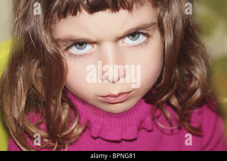 defy outface little girl portrait looking camera gesture blue eyes Stock Photo