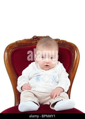Humorous photo of a four month old baby boy sitting in a chair like a king on a throne Stock Photo
