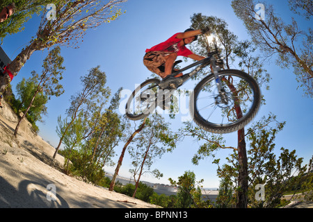 riding bmx and mountain bikes at the Oakley dirt jump track Stock Photo