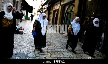 Four Palestinian women walking to the Al Aqsa mosque located on the temple mt. for the Friday prayers. Stock Photo