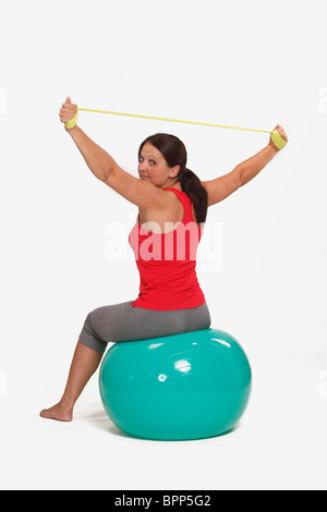 Woman, callistenic with theraband and stability ball / callistenics Stock Photo