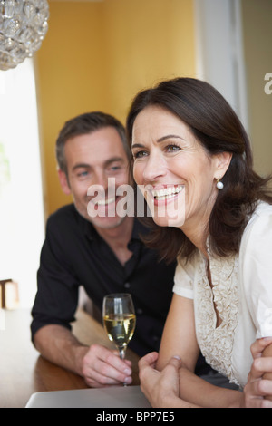 Couple sitting on table Stock Photo