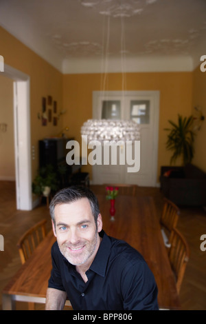 Man sitting in front of  table Stock Photo