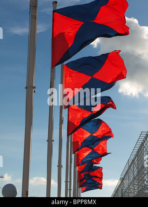 View looking up at colourful flags flying in the wind Stock Photo