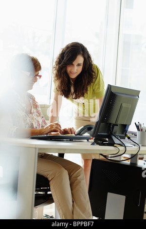 Two female colleagues working in office Stock Photo