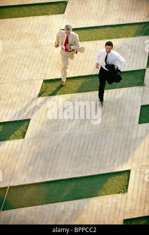 Two business men running Stock Photo