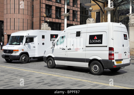 Side and front view of Loomis cash & valuables transport vans a business company operating high security armoured transportation in London England UK Stock Photo