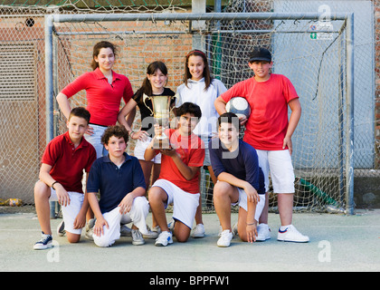 Winning team with a golden cup Stock Photo
