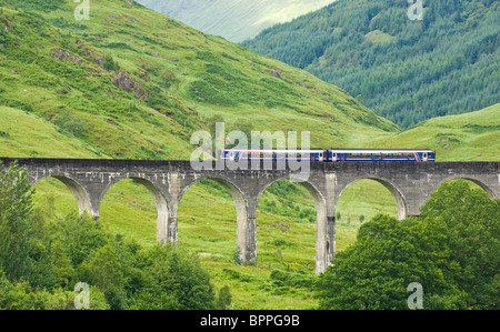 Local diesel commuter train stops on the Glenfinnan viaduct in order for its passengers to admire the scenic views