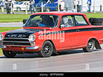 Red and Black Ford Lotus Cortina on Rally Circuit at Oulton Park Motor Racing Track Cheshire England United Kingdom UK Stock Photo