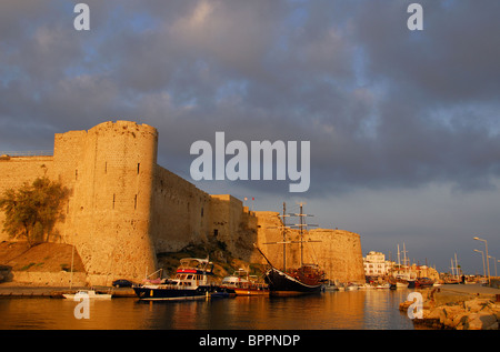 KYRENIA, NORTH CYPRUS. Morning light on Kyrenia castle and harbour, with stormy skies above. Stock Photo
