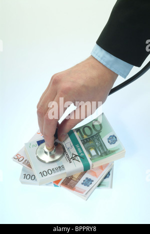 Hand with stethoscope doing a checkup on Euro banknotes Stock Photo
