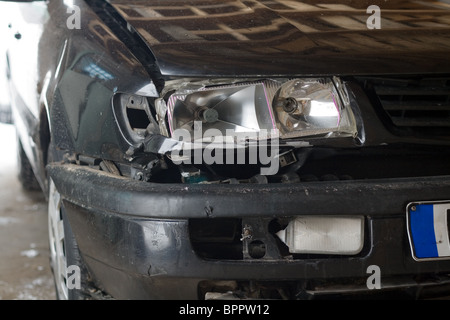 Broken Car after a Crash. Damaged Wing and Headlamp of a Car