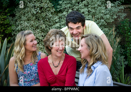 Happy family of four outside in their home garden Stock Photo