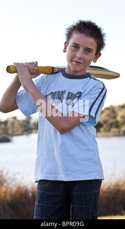 Young teenage boy holding a cricket bat Stock Photo