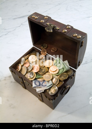 A treasure chest filled with money Stock Photo