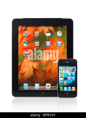 Apple iPad 3G tablet computer and iPhone 4 smartphone with desktop icons on their displays isolated on white background. HQ Stock Photo