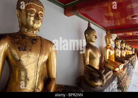 Row of buddha statues, Wat Pho, 17th century temple, Bangkok, Thailand Stock Photo