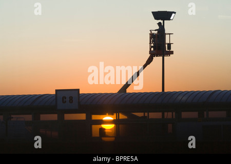 A man fixes a lamppost at the airport in Boise, Idaho. Stock Photo