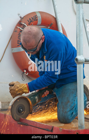 Ship's engineer, George Currie with the fishing boat, Vivienne Anne, at Portland in Victoria Stock Photo