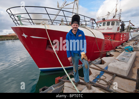 Ship's engineer, George Currie with the fishing boat, Vivienne Jane at Portland, Victoria Stock Photo