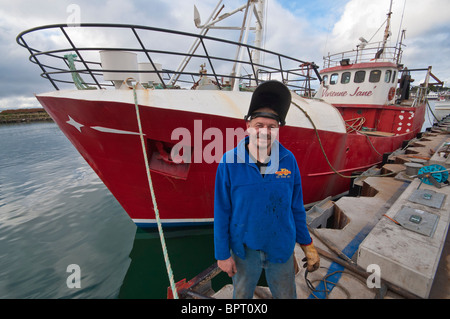 Ship's engineer, George Currie with the fishing boat, Vivienne Jane at Portland, Victoria Stock Photo