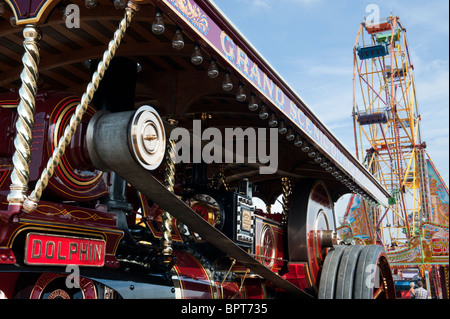 Showmans Traction Engine 'Dolphin' in front of a fairground ferris wheel at the Great Dorset steam fair 2010, England Stock Photo